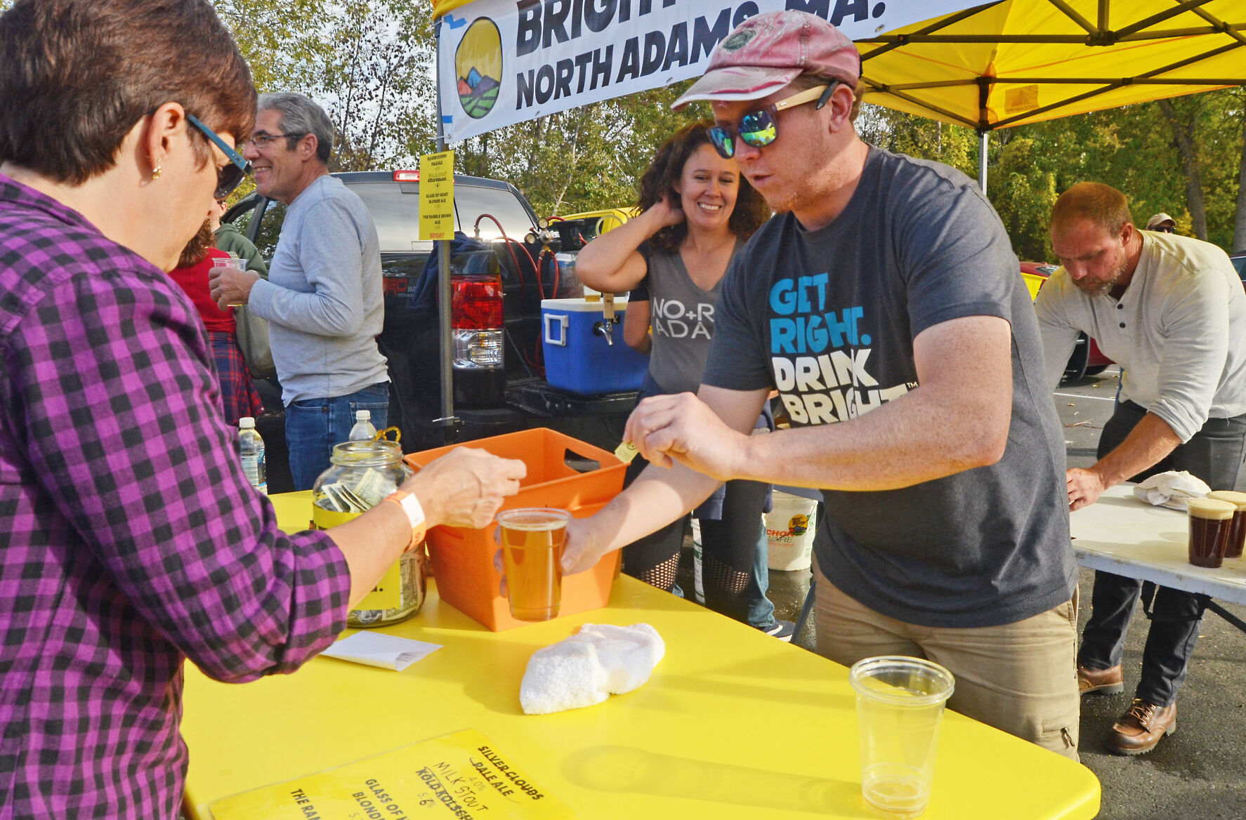 Man and woman serve beer